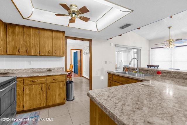 kitchen featuring sink, vaulted ceiling, ceiling fan, light tile patterned floors, and black range with electric cooktop