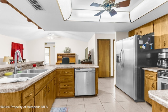 kitchen featuring kitchen peninsula, sink, stainless steel appliances, and lofted ceiling