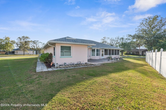 rear view of house with a lawn