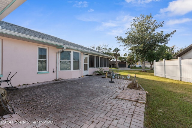 view of patio featuring a sunroom