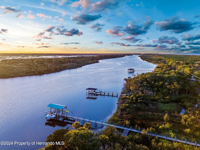 aerial view at dusk with a water view