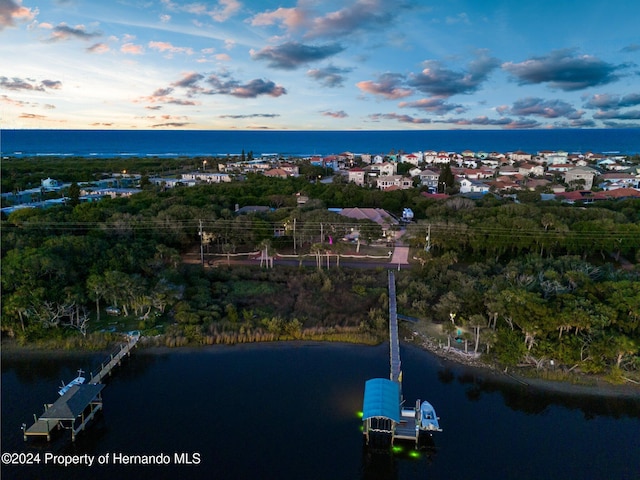 aerial view at dusk with a water view