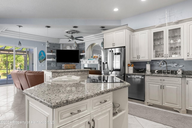 kitchen with appliances with stainless steel finishes, ceiling fan, sink, pendant lighting, and white cabinets