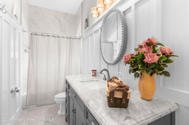 full bathroom featuring tile patterned floors, vanity, toilet, and shower / bathtub combination with curtain