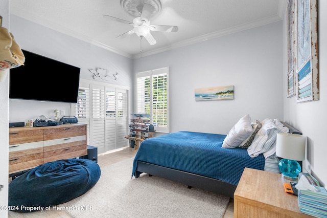 bedroom with ceiling fan, wood-type flooring, and ornamental molding