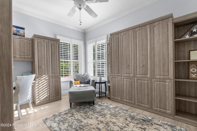 living area featuring a textured ceiling, ceiling fan, light wood-type flooring, and ornamental molding