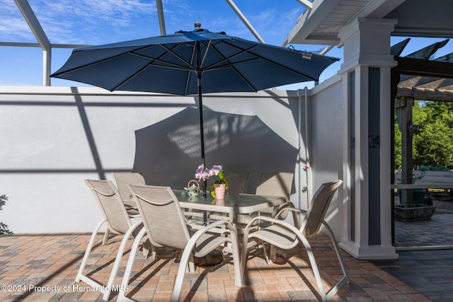 view of patio featuring a lanai