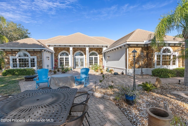 back of property featuring a patio and french doors