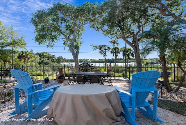 view of patio / terrace with a water view and grilling area