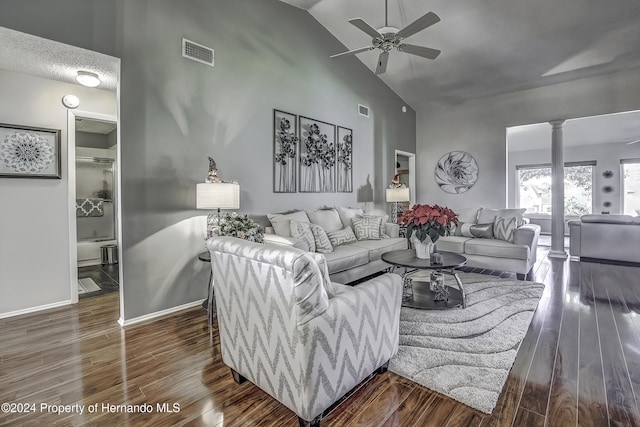 living room with decorative columns, ceiling fan, dark hardwood / wood-style flooring, and high vaulted ceiling