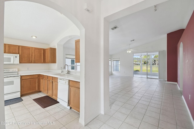 kitchen with ceiling fan, sink, lofted ceiling, white appliances, and light tile patterned floors