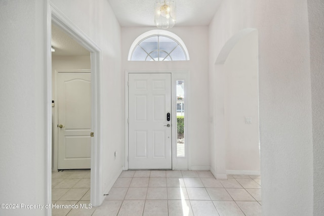 tiled entrance foyer featuring a textured ceiling