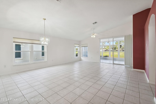 tiled spare room with ceiling fan with notable chandelier, a wealth of natural light, and lofted ceiling