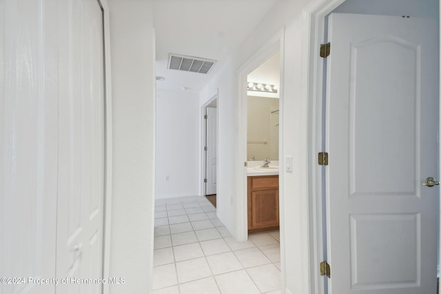 hall featuring light tile patterned floors