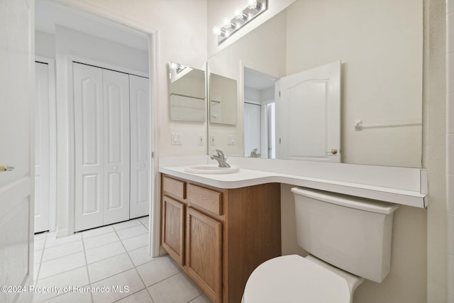 bathroom featuring tile patterned floors, vanity, and toilet