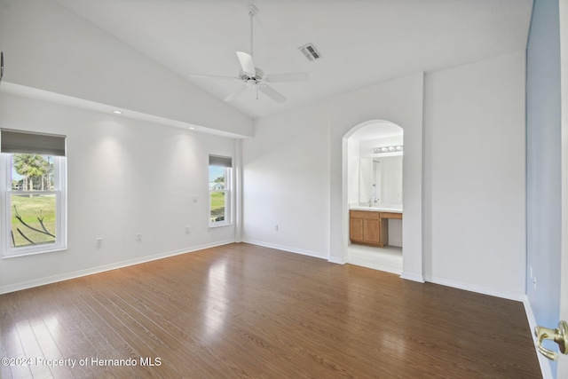 unfurnished room featuring wood-type flooring, high vaulted ceiling, a wealth of natural light, and ceiling fan