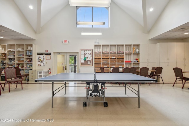 playroom featuring high vaulted ceiling