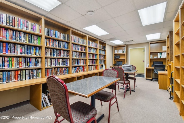 home office featuring light carpet and a drop ceiling