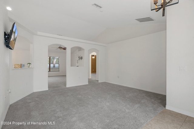 empty room with light carpet, ceiling fan, and lofted ceiling