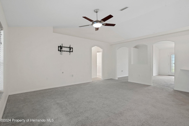 unfurnished room with light carpet, vaulted ceiling, and ceiling fan