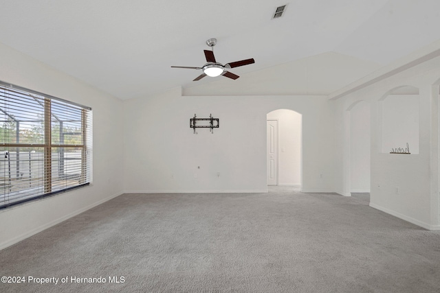 unfurnished room featuring ceiling fan, light carpet, and vaulted ceiling