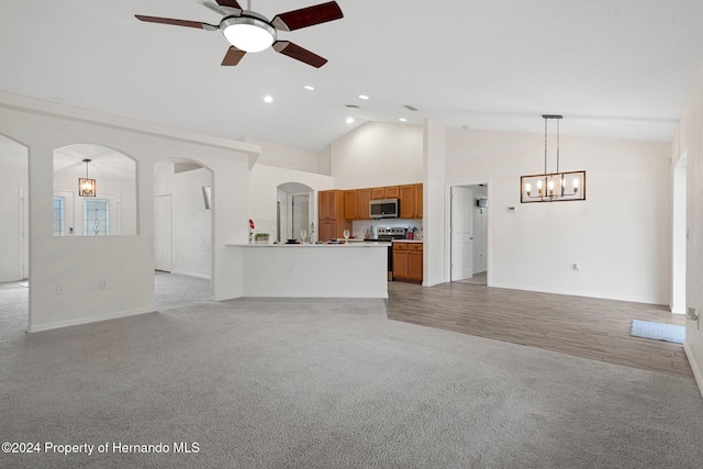 unfurnished living room with ceiling fan, light hardwood / wood-style floors, and high vaulted ceiling