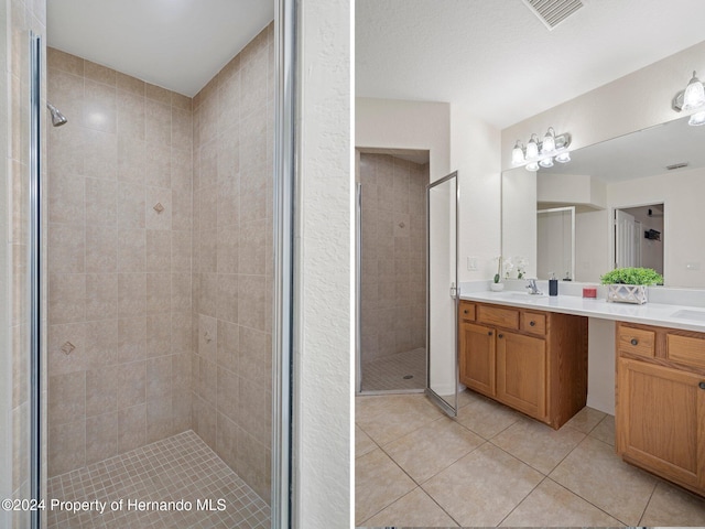 bathroom featuring a tile shower, vanity, and tile patterned floors