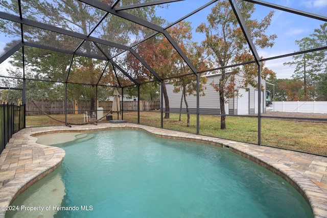 view of pool featuring a lawn and a lanai