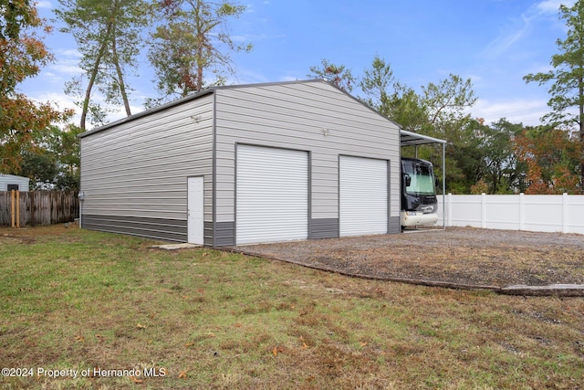 garage featuring a lawn