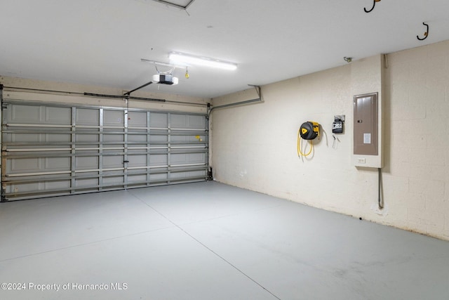 garage with electric panel and a garage door opener