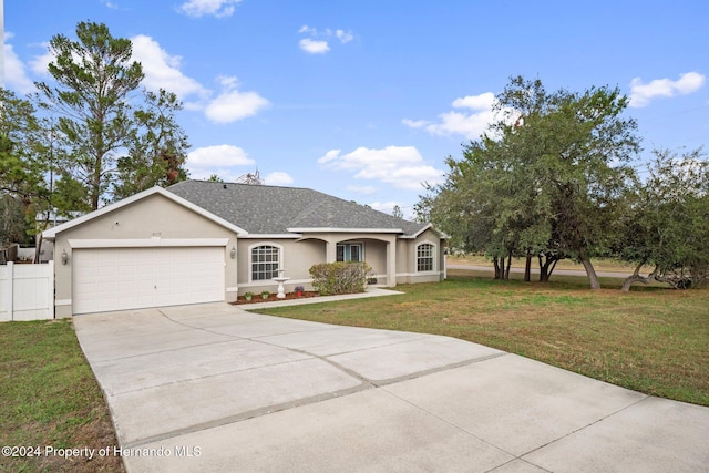 single story home featuring a garage and a front lawn