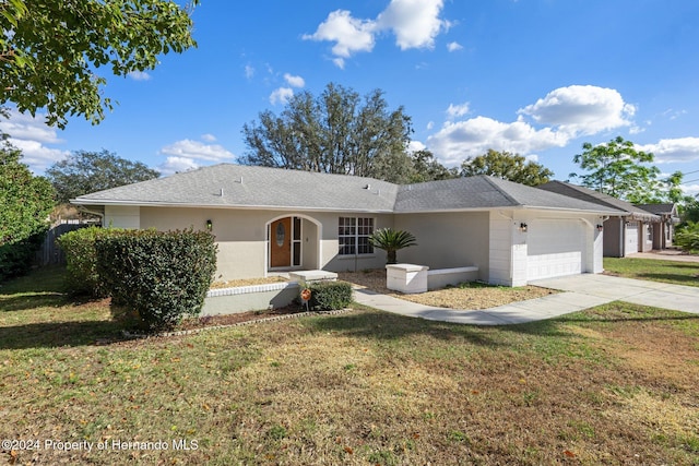 single story home featuring a front yard and a garage