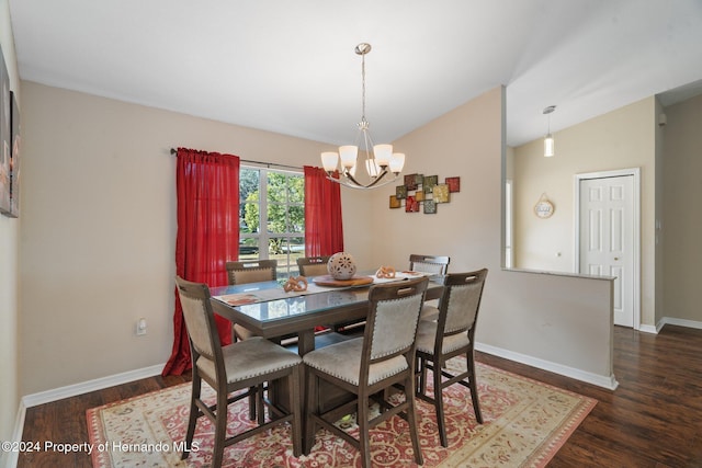 dining room with vaulted ceiling, dark wood-type flooring, and a notable chandelier