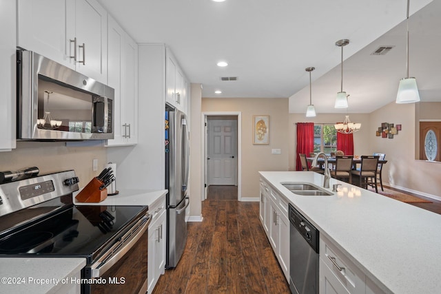 kitchen with white cabinetry, sink, dark hardwood / wood-style flooring, decorative light fixtures, and appliances with stainless steel finishes