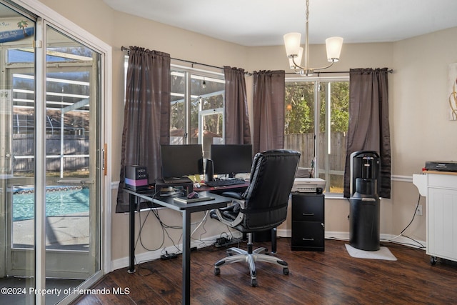 office with dark hardwood / wood-style floors, a wealth of natural light, and a chandelier