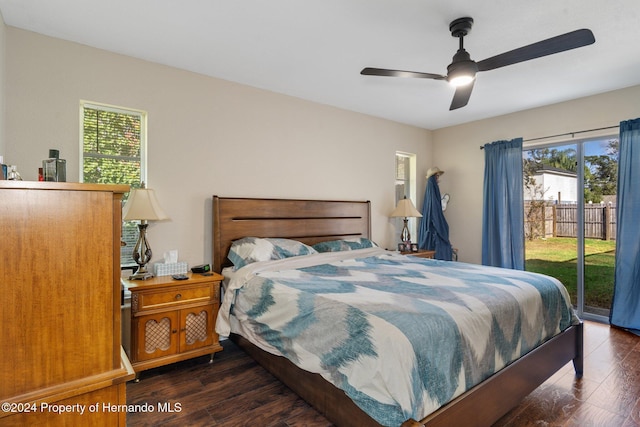 bedroom featuring access to outside, ceiling fan, and dark hardwood / wood-style flooring