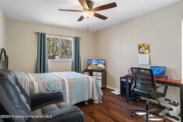 bedroom with ceiling fan and dark hardwood / wood-style floors