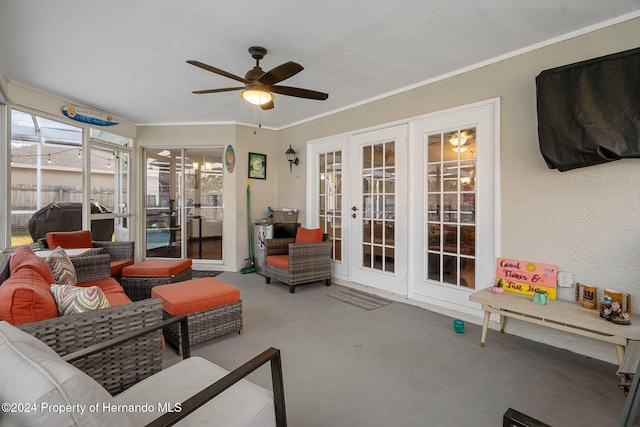 sunroom / solarium featuring french doors and ceiling fan