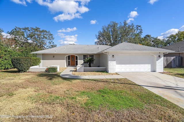 ranch-style home with a front yard and a garage