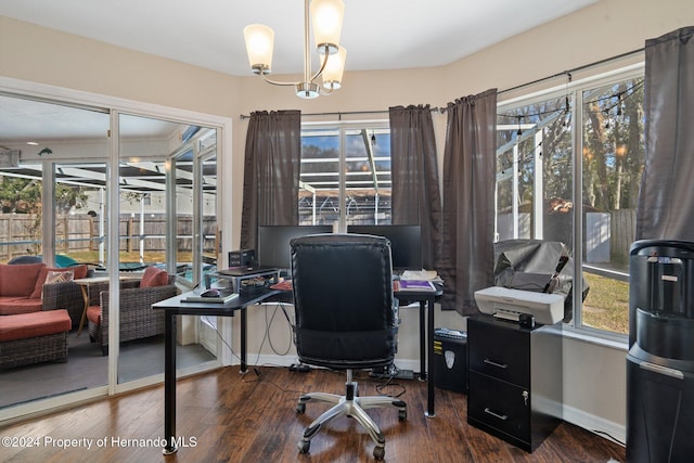 office area featuring plenty of natural light, dark hardwood / wood-style floors, and an inviting chandelier