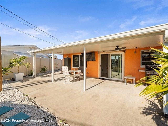 rear view of house with a patio area and ceiling fan