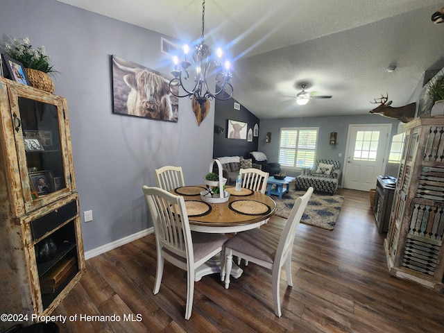 dining space featuring a textured ceiling, dark hardwood / wood-style flooring, ceiling fan with notable chandelier, and vaulted ceiling