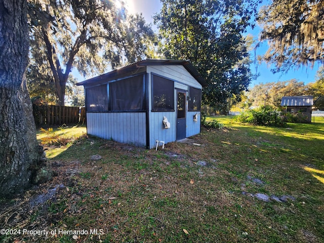 view of outbuilding with a yard