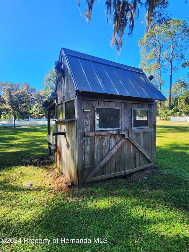 view of outdoor structure featuring a lawn