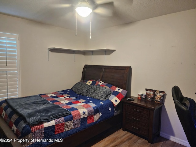 bedroom with ceiling fan and wood-type flooring