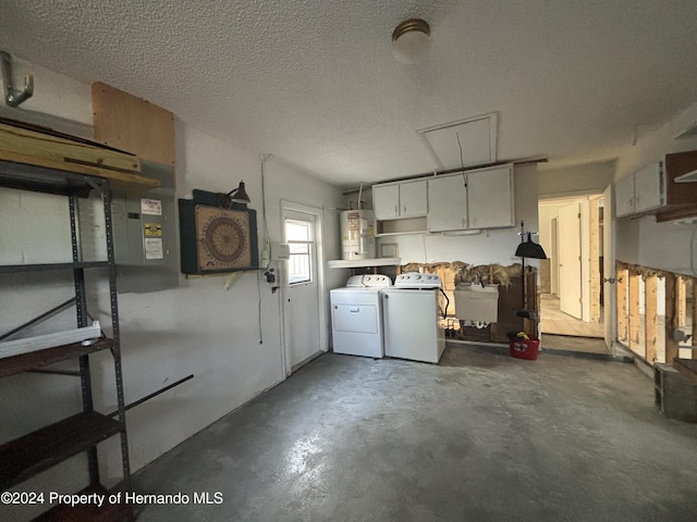 garage with water heater and washer and dryer