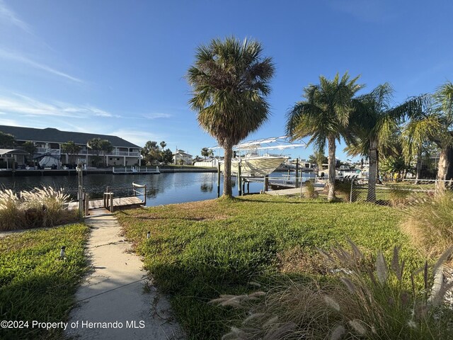 exterior space with a water view and a boat dock