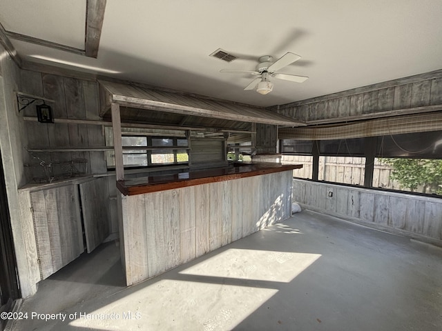 kitchen with ceiling fan and concrete flooring