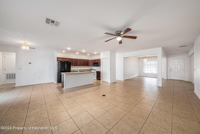 unfurnished living room with light tile patterned floors and ceiling fan with notable chandelier