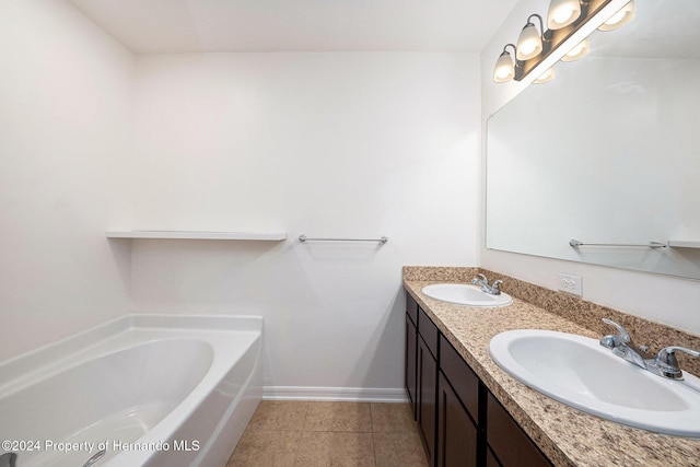 bathroom with vanity, a tub to relax in, and tile patterned floors